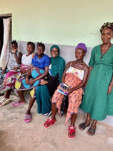 Pregnant women seated together on a bench at a health facility