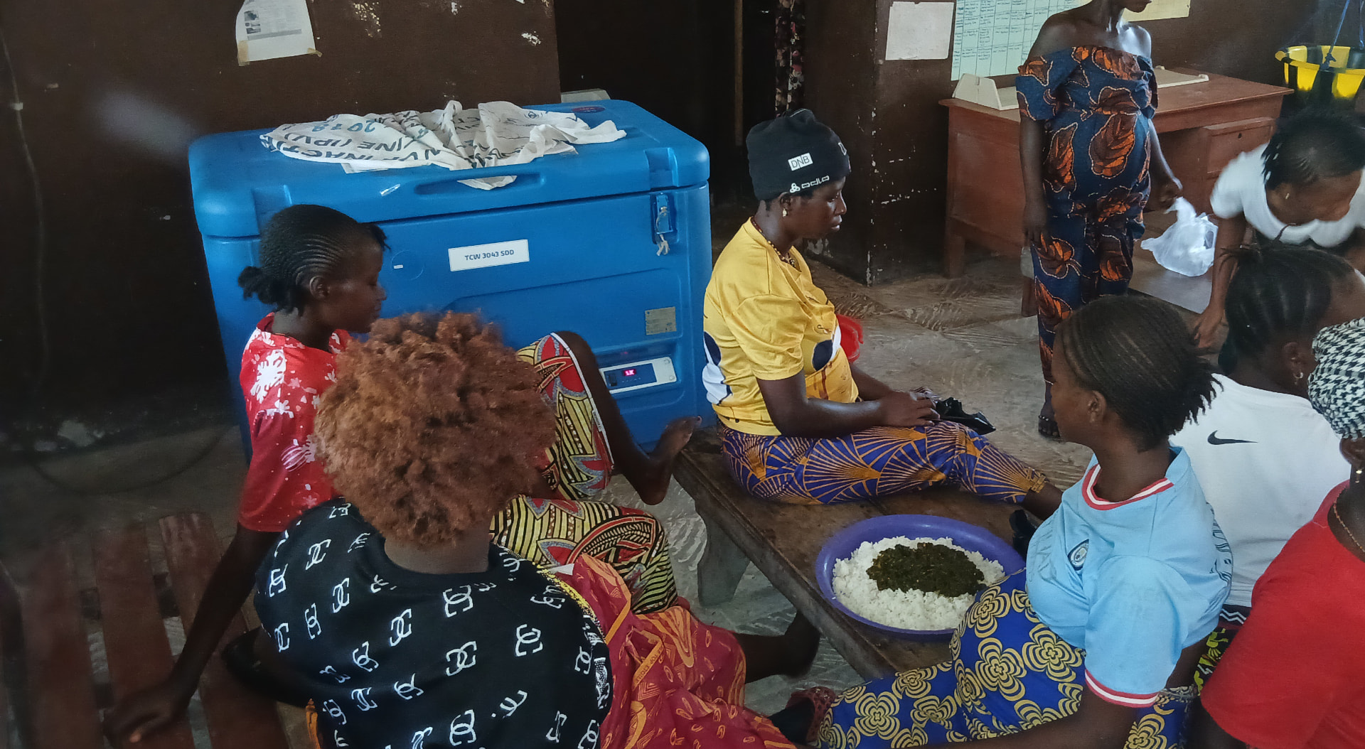 A group of women seated together inside a health facility